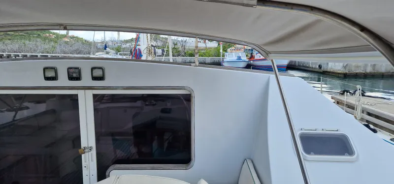 Lambada Yacht Photos Pics Cockpit view of 1993 Lagoon 47 catamaran docked at a marina.