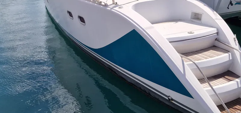 Lambada Yacht Photos Pics Lagoon 47 catamaran from 1993 with sleek design and blue accent on the hull.