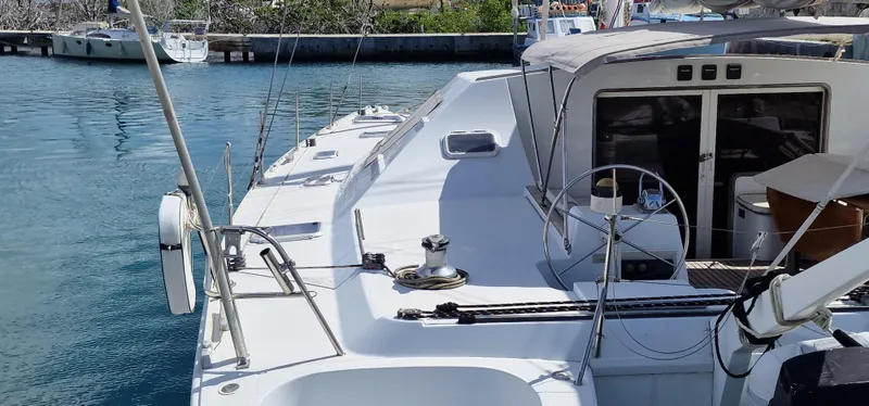 Lambada Yacht Photos Pics 1993 Lagoon 47 catamaran docked in a serene marina setting.