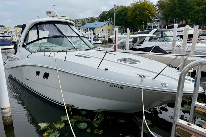 Flip Side Yacht Photos Pics 2010 Sea Ray 330 Sundancer docked at a marina, surrounded by other boats.