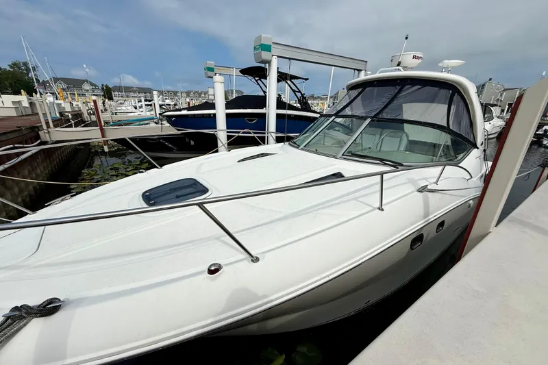 Flip Side Yacht Photos Pics 2010 Sea Ray 330 Sundancer docked at a marina under a cloudy sky.
