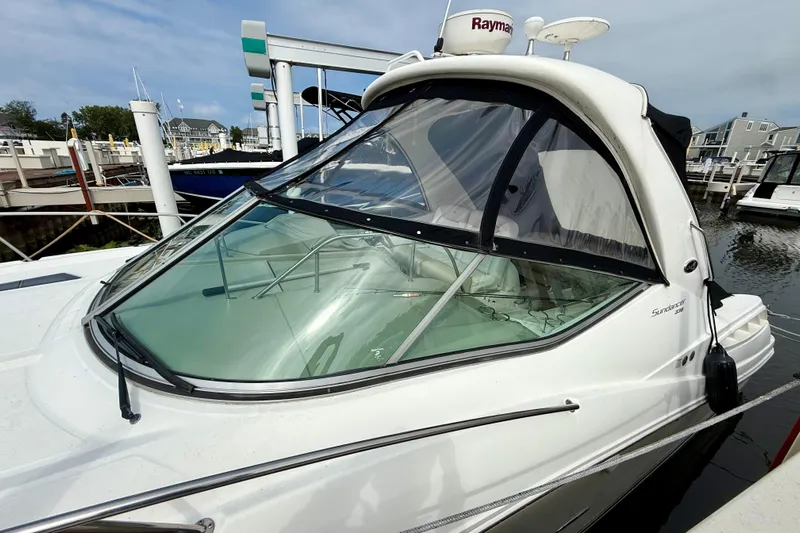 Flip Side Yacht Photos Pics 2010 Sea Ray 330 Sundancer docked at marina, featuring sleek design and clear canopy.
