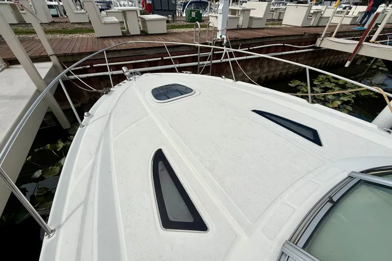 Flip Side Yacht Photos Pics 2010 Sea Ray 330 Sundancer boat docked, showcasing sleek deck design and windows.