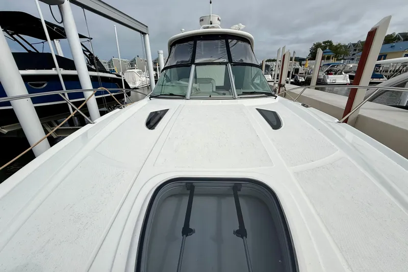 Flip Side Yacht Photos Pics 2010 Sea Ray 330 Sundancer yacht docked at marina, front deck view.