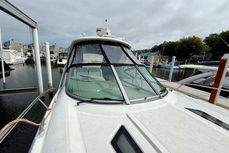 Flip Side Yacht Photos Pics 2010 Sea Ray 330 Sundancer docked at a marina under cloudy skies.