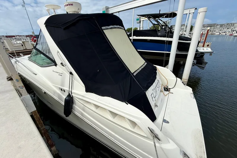 Flip Side Yacht Photos Pics 2010 Sea Ray 330 Sundancer docked at marina, covered with black canopy.