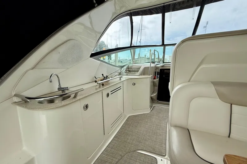 Flip Side Yacht Photos Pics Interior of 2010 Sea Ray 330 Sundancer yacht with kitchenette and seating area.