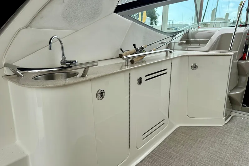 Flip Side Yacht Photos Pics 2010 Sea Ray 330 Sundancer yacht interior with sink and storage cabinets.