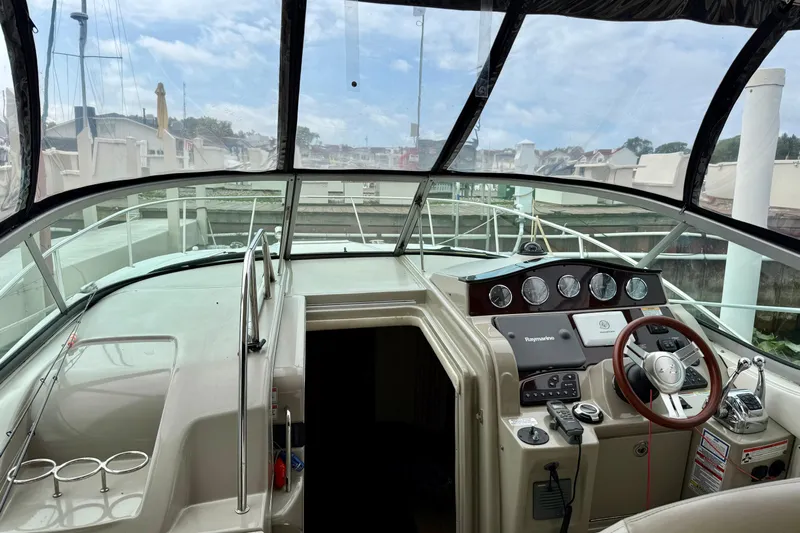 Flip Side Yacht Photos Pics 2010 Sea Ray 330 Sundancer cockpit with steering wheel and control panel.