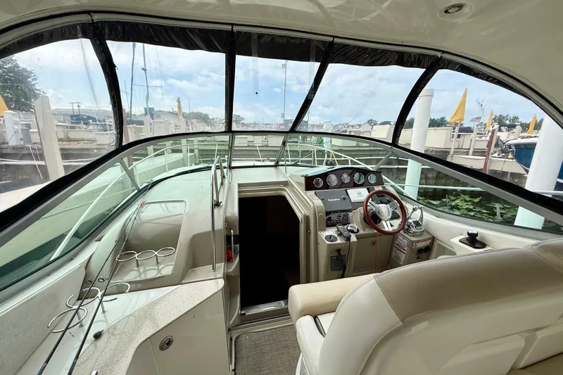 Flip Side Yacht Photos Pics Interior view of 2010 Sea Ray 330 Sundancer yacht cockpit with steering wheel and dashboard.