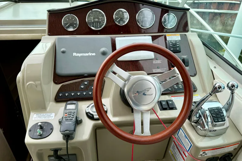 Flip Side Yacht Photos Pics Steering console of a 2010 Sea Ray 330 Sundancer with Raymarine navigation system.