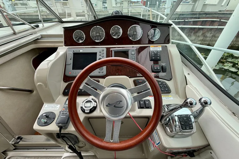 Flip Side Yacht Photos Pics Cockpit of 2010 Sea Ray 330 Sundancer with steering wheel and control panel.