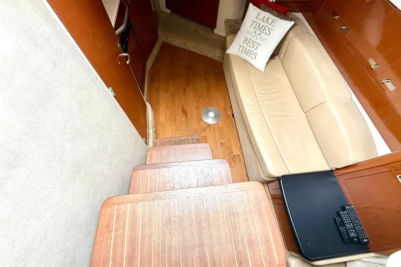 Flip Side Yacht Photos Pics Interior of 2010 Sea Ray 330 Sundancer with beige seating and wooden flooring.