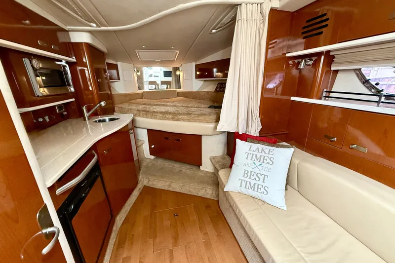 Flip Side Yacht Photos Pics Luxurious interior of 2010 Sea Ray 330 Sundancer yacht with cozy seating and kitchenette.