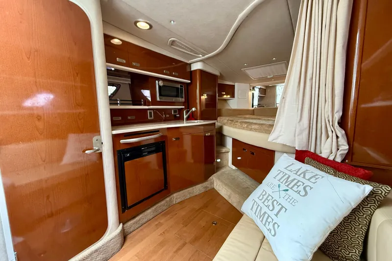 Flip Side Yacht Photos Pics Interior of 2010 Sea Ray 330 Sundancer with kitchenette and cozy seating area.