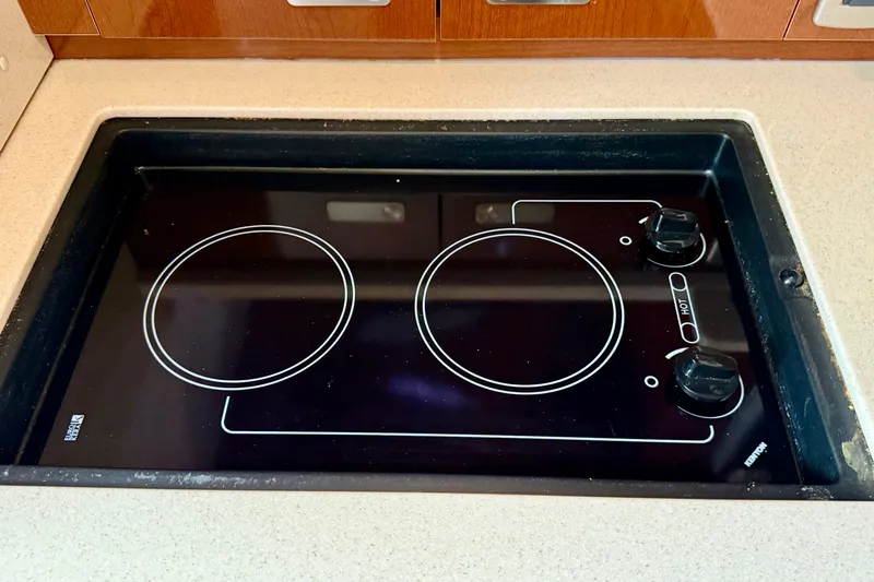 Flip Side Yacht Photos Pics Built-in electric stove on 2010 Sea Ray 330 Sundancer yacht kitchen.