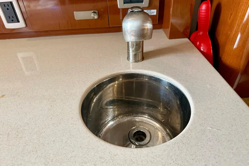 Flip Side Yacht Photos Pics Stainless steel sink on 2010 Sea Ray 330 Sundancer yacht with modern faucet and countertop.