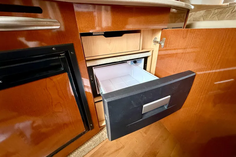 Flip Side Yacht Photos Pics Interior of 2010 Sea Ray 330 Sundancer showing open drawer and cabinetry.
