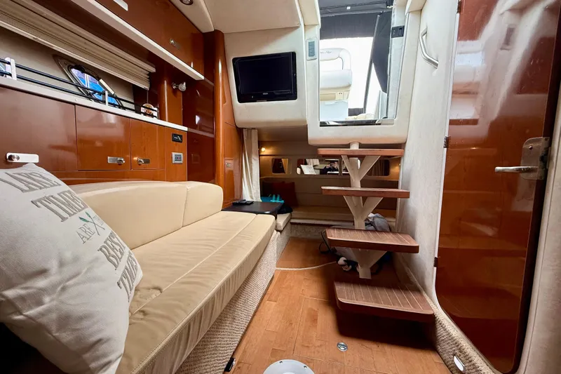 Flip Side Yacht Photos Pics Interior of 2010 Sea Ray 330 Sundancer yacht with cozy seating and wooden steps.