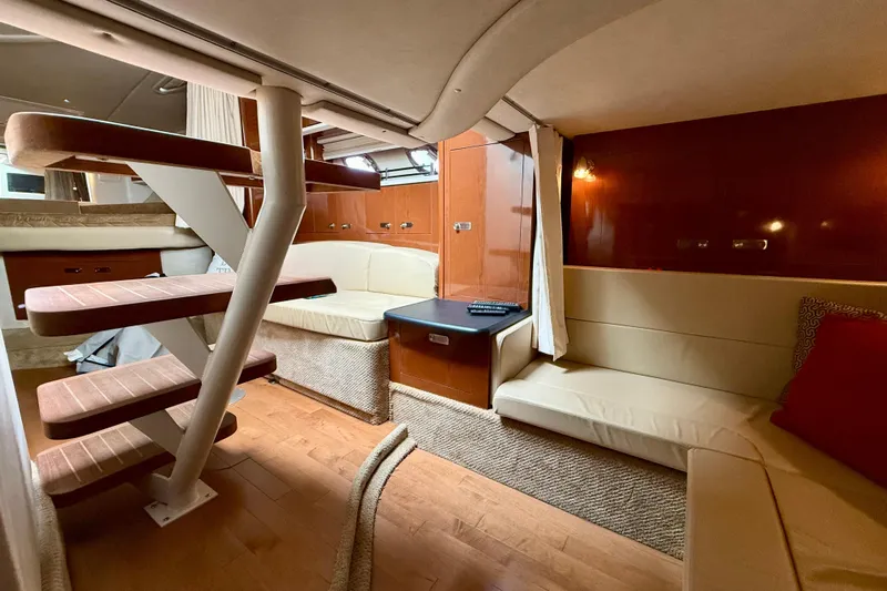 Flip Side Yacht Photos Pics Interior of 2010 Sea Ray 330 Sundancer yacht with cozy seating and wooden stairs.