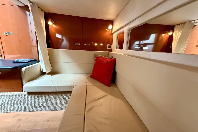 Flip Side Yacht Photos Pics Interior of 2010 Sea Ray 330 Sundancer with beige seating and red pillow.