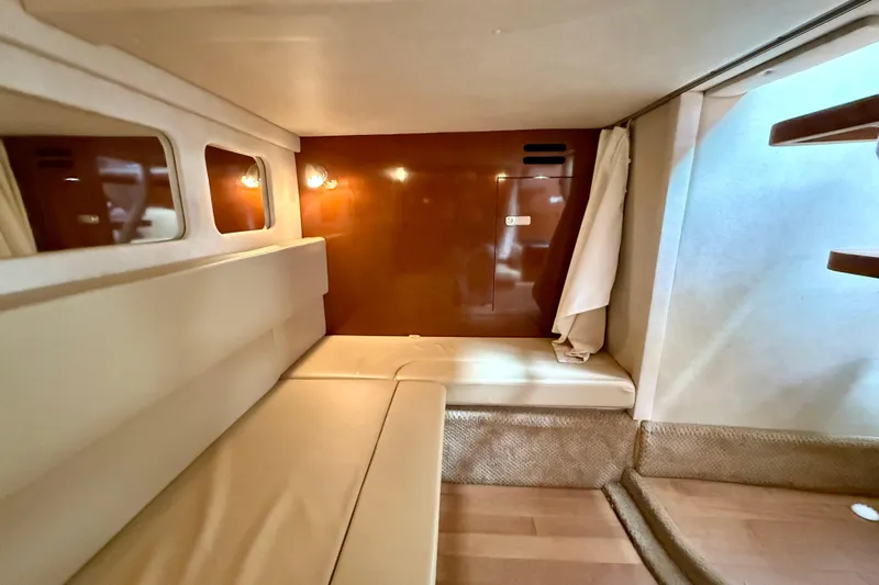 Flip Side Yacht Photos Pics Interior cabin of 2010 Sea Ray 330 Sundancer with beige seating and wooden accents.