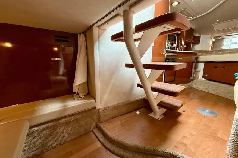 Flip Side Yacht Photos Pics Interior of 2010 Sea Ray 330 Sundancer yacht with wooden stairs and modern kitchen.
