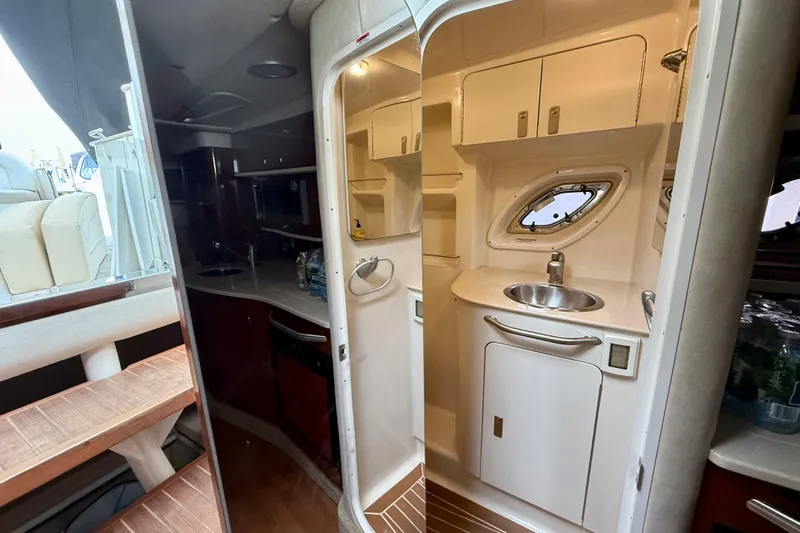 Flip Side Yacht Photos Pics Interior of 2010 Sea Ray 330 Sundancer yacht, featuring kitchenette and bathroom.