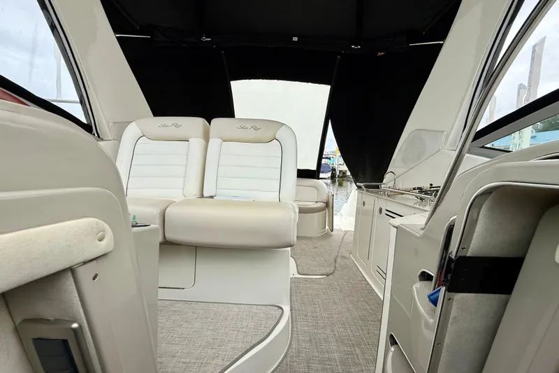 Flip Side Yacht Photos Pics Interior view of 2010 Sea Ray 330 Sundancer yacht with beige seating and kitchenette.