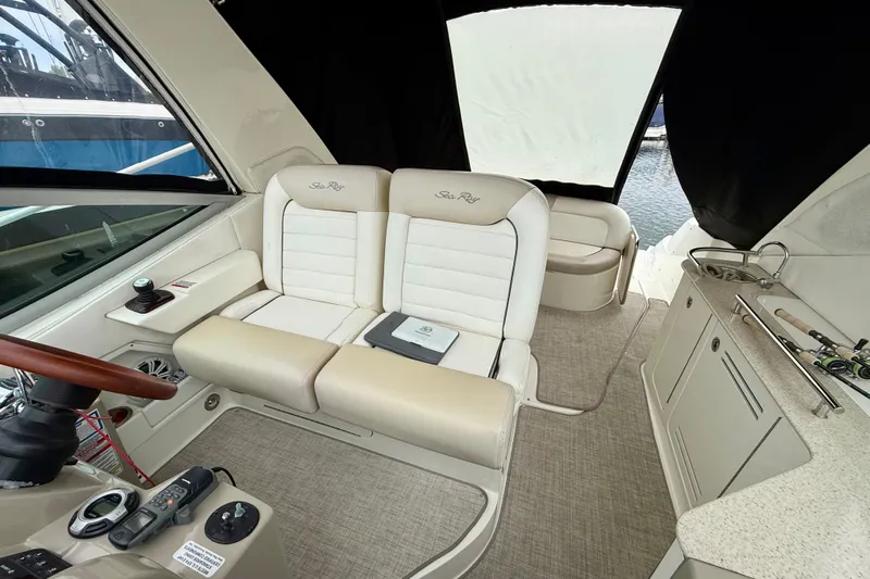 Flip Side Yacht Photos Pics Interior of 2010 Sea Ray 330 Sundancer yacht with plush seating and control panel.
