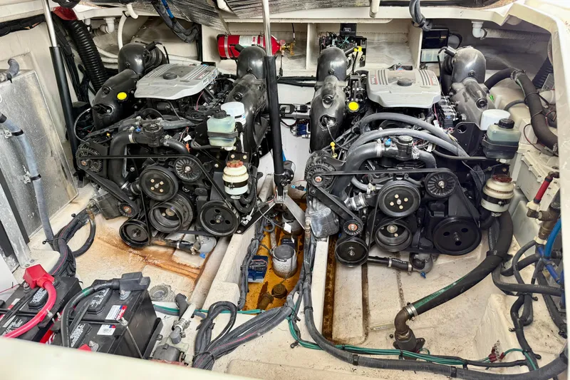 Flip Side Yacht Photos Pics Engine room of a 2010 Sea Ray 330 Sundancer with dual engines and mechanical components.