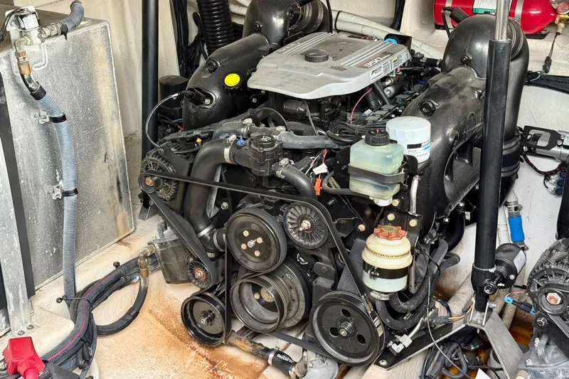 Flip Side Yacht Photos Pics Engine compartment of a 2010 Sea Ray 330 Sundancer boat, showcasing mechanical components.