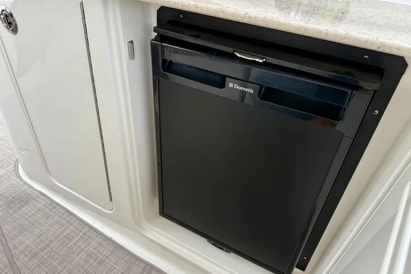 Flip Side Yacht Photos Pics Dometic refrigerator on 2010 Sea Ray 330 Sundancer yacht, featuring sleek design and functionality.