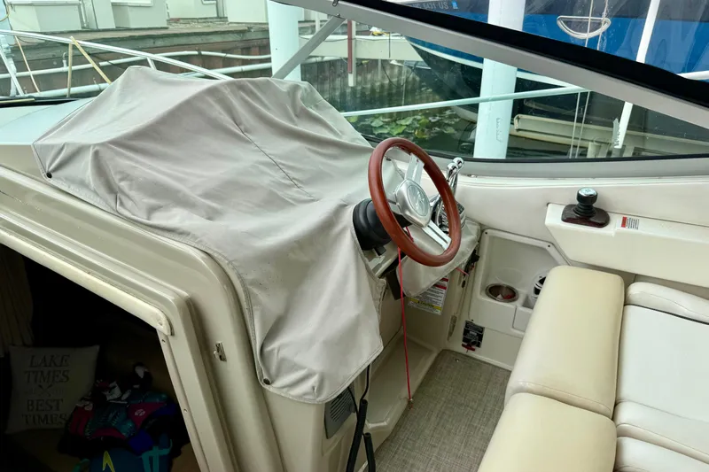 Flip Side Yacht Photos Pics Interior view of a 2010 Sea Ray 330 Sundancer boat cockpit with covered controls.