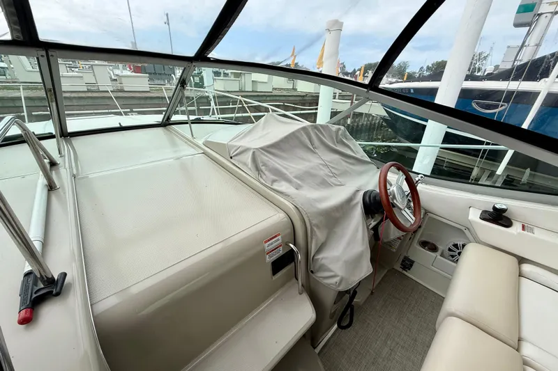 Flip Side Yacht Photos Pics 2010 Sea Ray 330 Sundancer cockpit with covered helm, docked at marina.