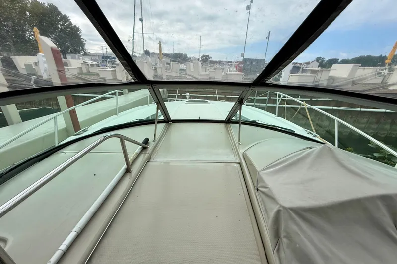 Flip Side Yacht Photos Pics 2010 Sea Ray 330 Sundancer boat interior view with glass canopy and docked surroundings.