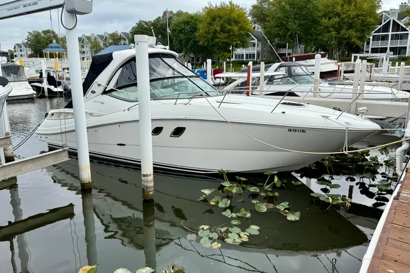 Flip Side Yacht Photos Pics 2010 Sea Ray 330 Sundancer docked at a marina with surrounding boats and greenery.