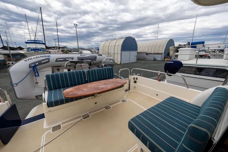 Power Play Yacht Photos Pics 2014 Sabre 38 Salon Express yacht with outdoor seating and docked boats in the background.