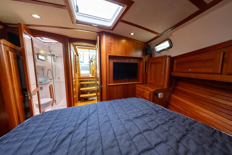 Power Play Yacht Photos Pics 2014 Sabre 38 Salon Express cabin with wood interior, bed, TV, and bathroom.