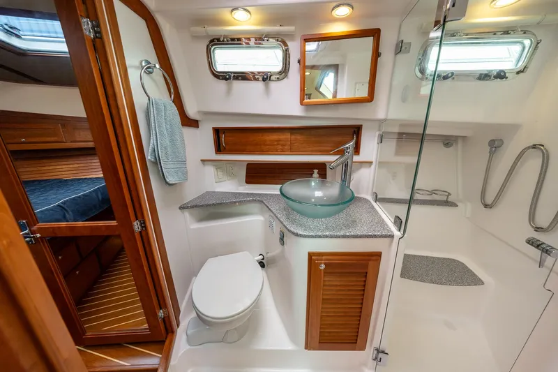 Power Play Yacht Photos Pics Luxurious bathroom in 2014 Sabre 38 Salon Express yacht with modern fixtures and wood accents.