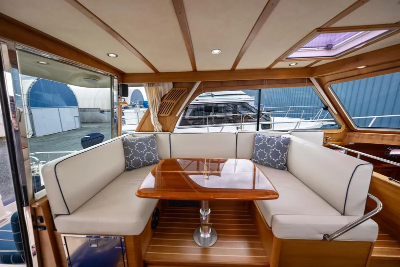 Power Play Yacht Photos Pics 2014 Sabre 38 Salon Express interior with elegant wood finish and cushioned seating.