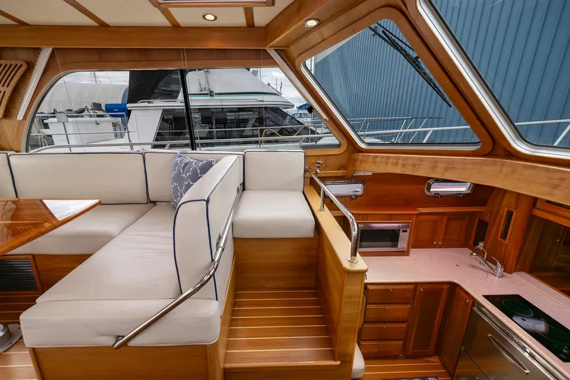 Power Play Yacht Photos Pics Interior of 2014 Sabre 38 Salon Express yacht with wood finish and seating area.