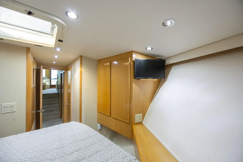  Yacht Photos Pics Interior of 2000 Hatteras 50 Convertible yacht bedroom with TV and modern lighting.