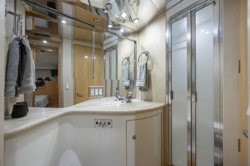  Yacht Photos Pics Luxurious bathroom in 2000 Hatteras 50 Convertible yacht with modern fixtures and frosted glass shower.