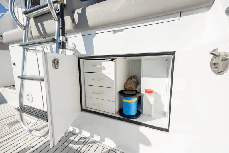  Yacht Photos Pics Storage compartment on 2000 Hatteras 50 Convertible yacht with ladder and equipment.