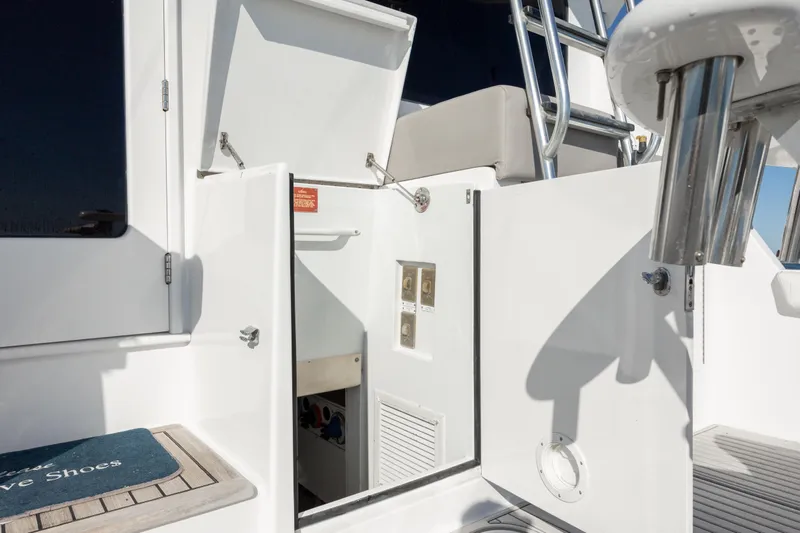  Yacht Photos Pics 2000 Hatteras 50 Convertible yacht, open storage compartment, stainless steel ladder, and deck details.