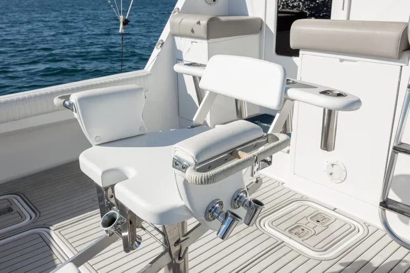  Yacht Photos Pics Fishing chair on 2000 Hatteras 50 Convertible yacht deck, overlooking ocean waters.