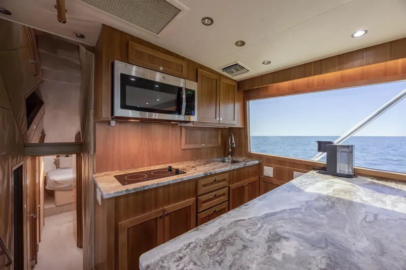  Yacht Photos Pics Luxurious kitchen interior of 2000 Hatteras 50 Convertible yacht with ocean view.