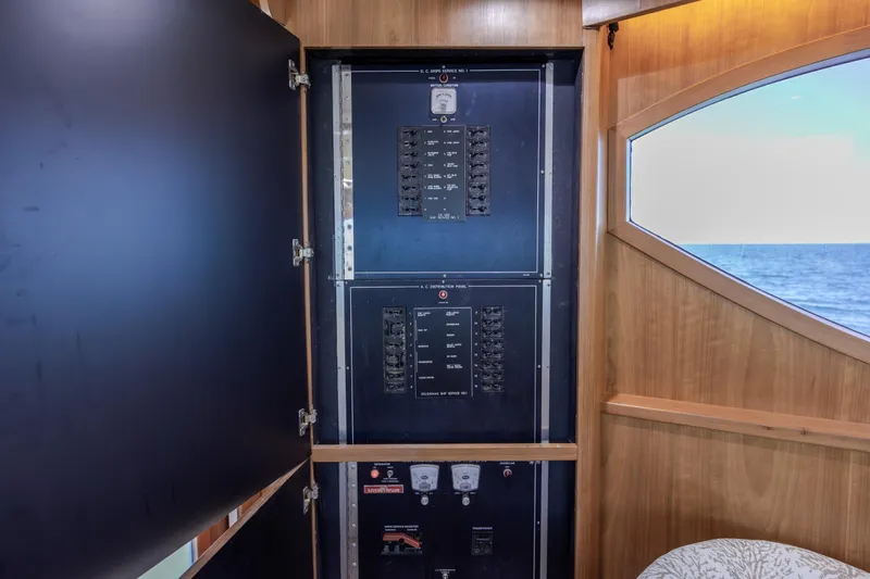  Yacht Photos Pics Electrical panel inside 2000 Hatteras 50 Convertible yacht, with ocean view through window.