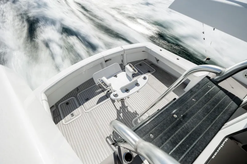  Yacht Photos Pics Hatteras 50 Convertible 2000 yacht deck with fishing chair, cruising on water.